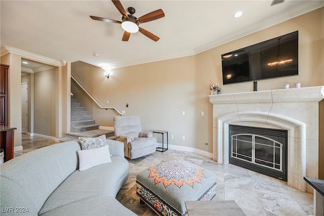 living room with crown molding, stairway, a glass covered fireplace, ceiling fan, and baseboards