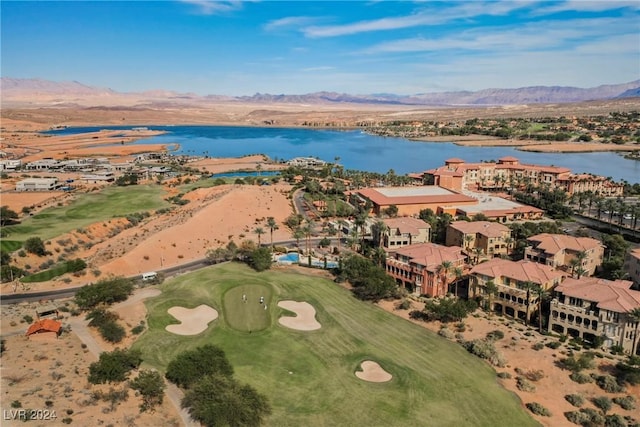 drone / aerial view featuring golf course view and a water and mountain view