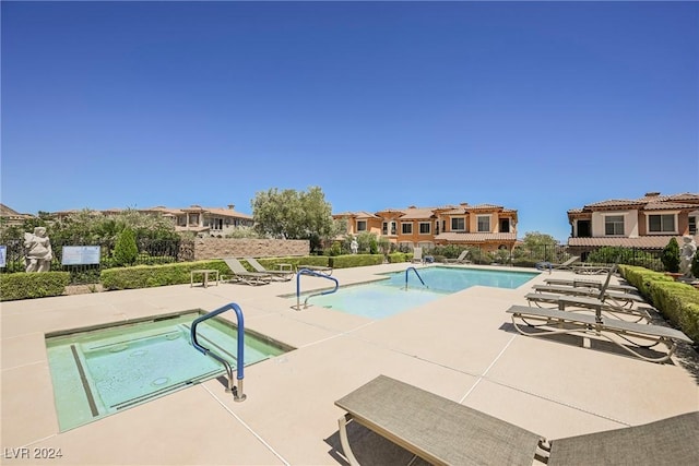 community pool with a residential view, a patio, and fence