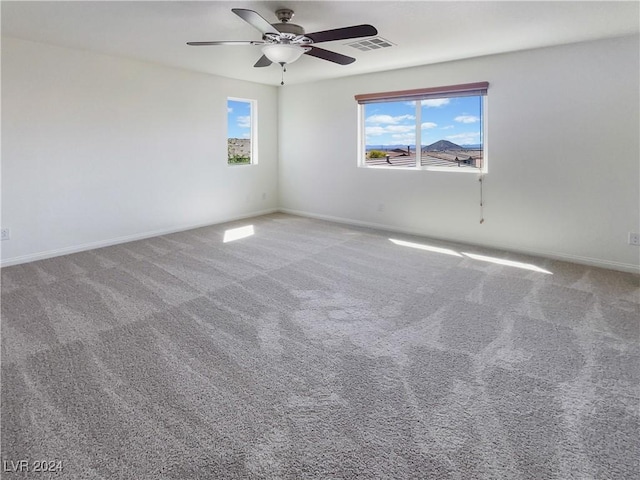 spare room with carpet and ceiling fan