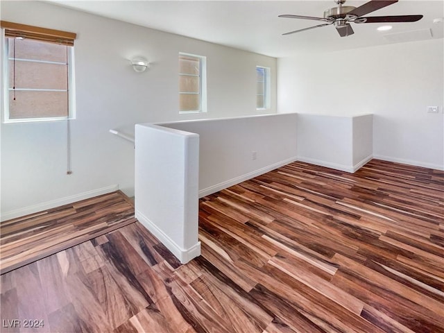 spare room with dark hardwood / wood-style floors and ceiling fan