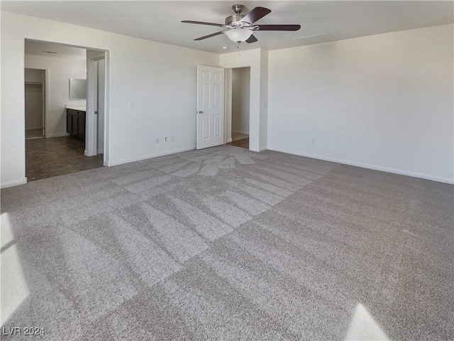 unfurnished bedroom with carpet floors, connected bathroom, and ceiling fan