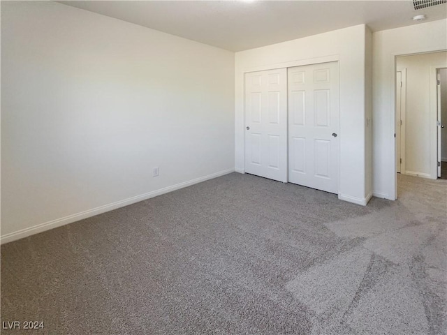 unfurnished bedroom featuring a closet and carpet floors