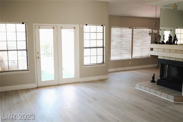 unfurnished living room with a wealth of natural light and light wood-type flooring