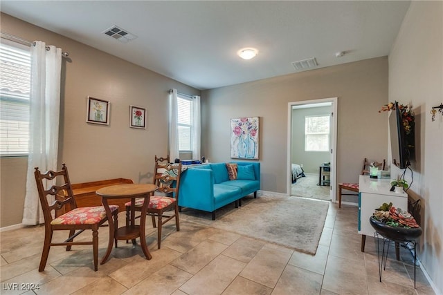 sitting room featuring plenty of natural light, visible vents, and light tile patterned flooring