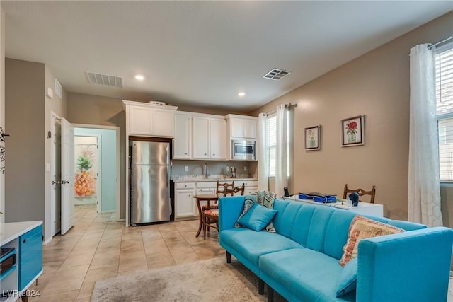 living area featuring recessed lighting, visible vents, and light tile patterned floors