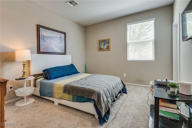 carpeted bedroom with visible vents and baseboards