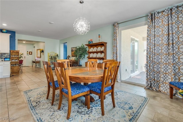 dining area with light tile patterned floors, a notable chandelier, and recessed lighting