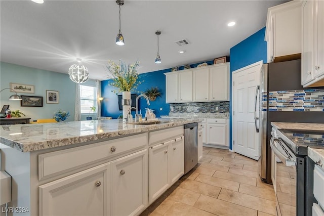 kitchen with visible vents, white cabinets, an island with sink, stainless steel appliances, and a sink