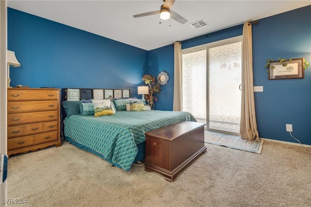 carpeted bedroom featuring ceiling fan, visible vents, and access to exterior