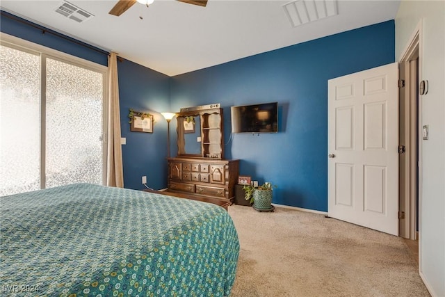 carpeted bedroom featuring a ceiling fan, visible vents, and baseboards