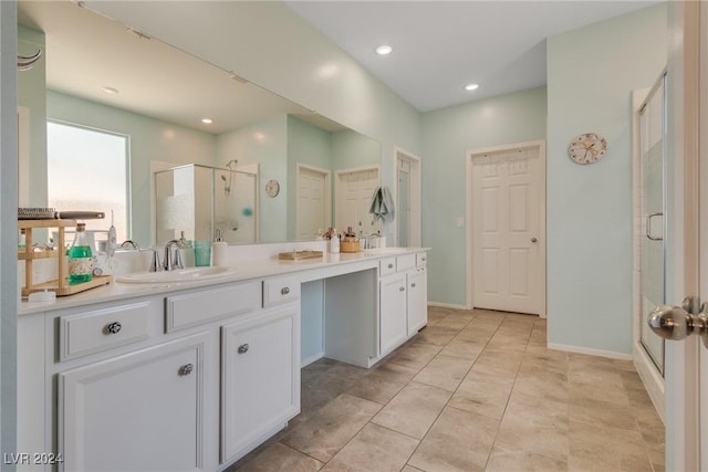 full bath featuring a stall shower, a sink, recessed lighting, and double vanity