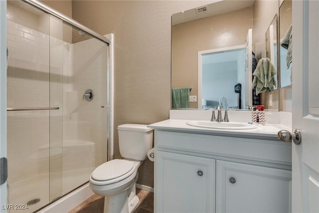 bathroom featuring a stall shower, visible vents, toilet, tile patterned floors, and vanity