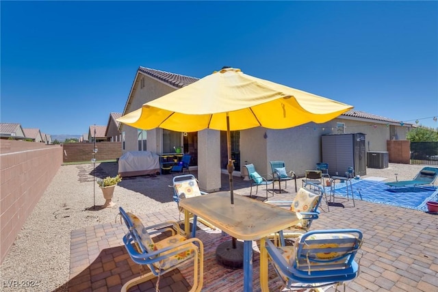 view of patio / terrace featuring cooling unit and a fenced backyard