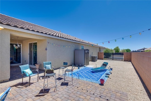 view of swimming pool featuring cooling unit, a patio area, and a fenced backyard