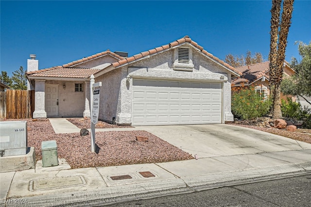 ranch-style home featuring a garage