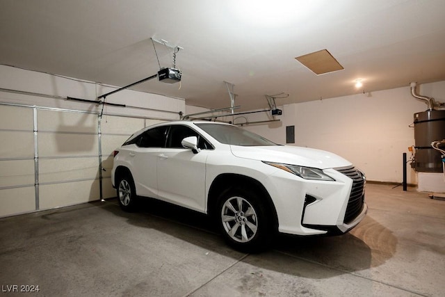 garage featuring a garage door opener and strapped water heater