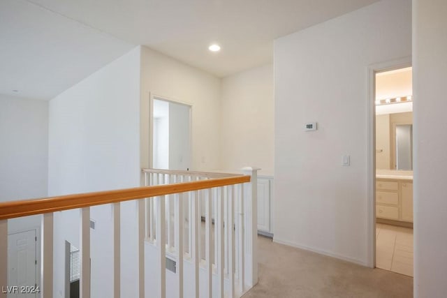 hall with recessed lighting and light colored carpet