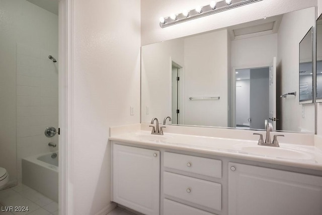 bathroom with bathtub / shower combination, a sink, toilet, and double vanity