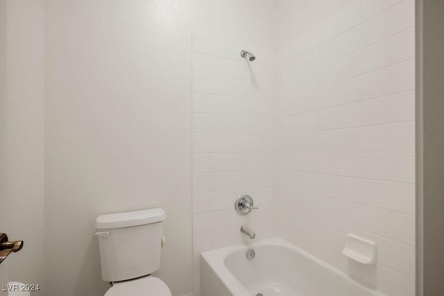 bathroom featuring bathing tub / shower combination and toilet