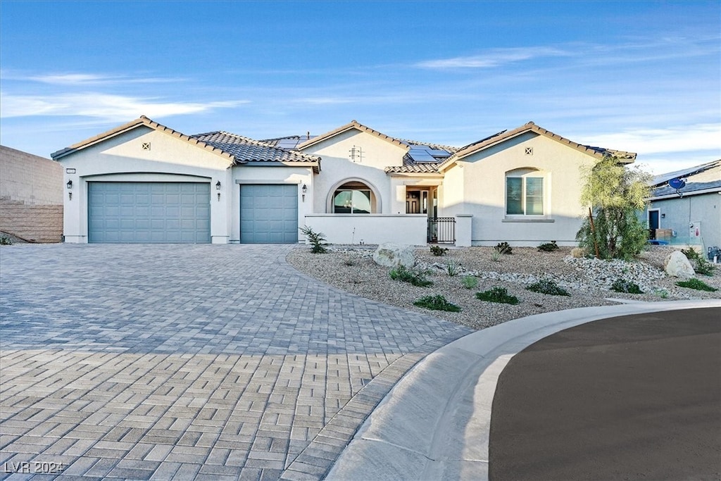 mediterranean / spanish house with a garage