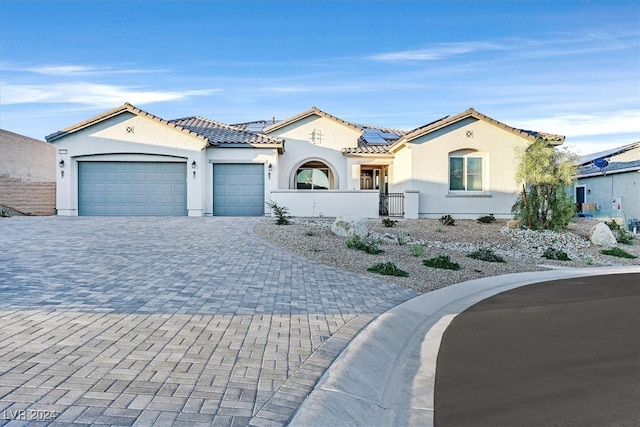 mediterranean / spanish house with a garage