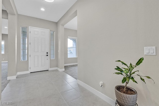 foyer entrance with light tile patterned floors