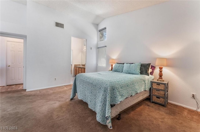 carpeted bedroom with ensuite bath, high vaulted ceiling, and a textured ceiling