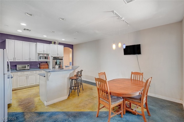 dining space featuring track lighting