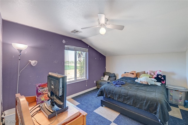 bedroom with carpet floors, vaulted ceiling, ceiling fan, and a textured ceiling