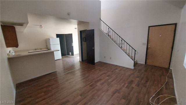 unfurnished living room with dark hardwood / wood-style flooring