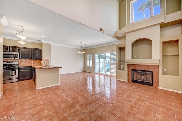 interior space featuring light tile patterned floors, a fireplace, visible vents, and ornamental molding