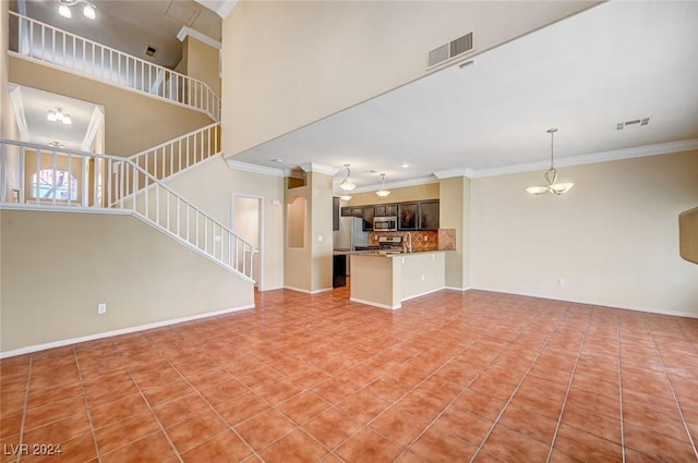 unfurnished living room featuring stairs, a notable chandelier, visible vents, and crown molding