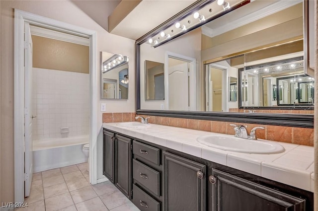 bathroom with washtub / shower combination, tile patterned flooring, a sink, and double vanity