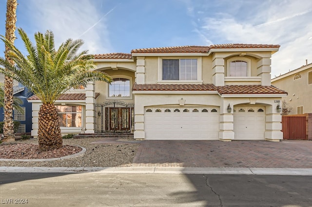 mediterranean / spanish-style home with a garage