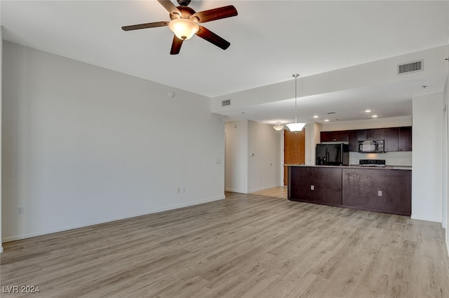 unfurnished living room featuring ceiling fan and light hardwood / wood-style flooring