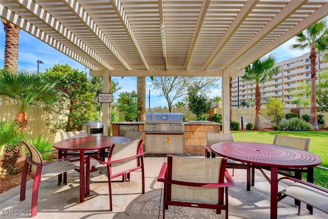 view of patio featuring exterior kitchen, outdoor dining space, a grill, and a pergola