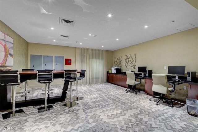 carpeted office featuring recessed lighting, visible vents, and a bar