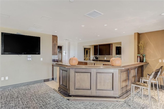 kitchen featuring recessed lighting, light countertops, visible vents, a sink, and baseboards