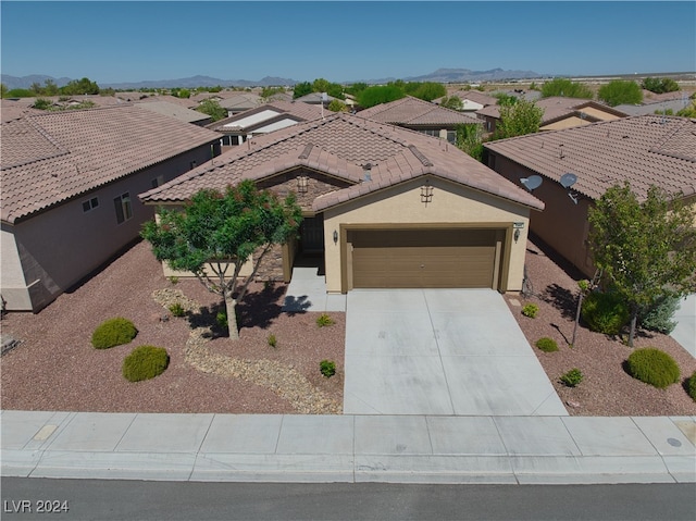 view of front of house with a mountain view and a garage