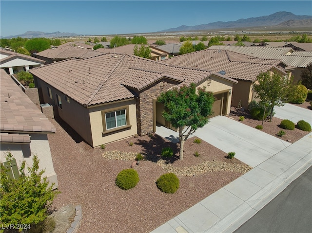 view of front of house with a garage and a mountain view