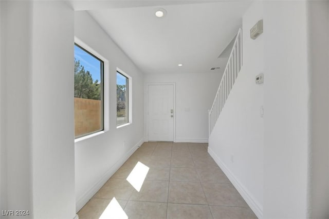 corridor featuring light tile patterned floors