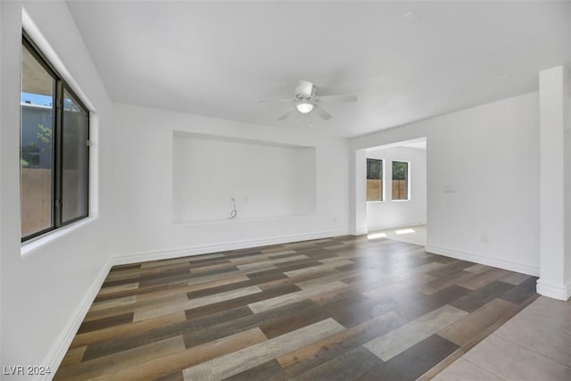 unfurnished room featuring ceiling fan and dark hardwood / wood-style flooring