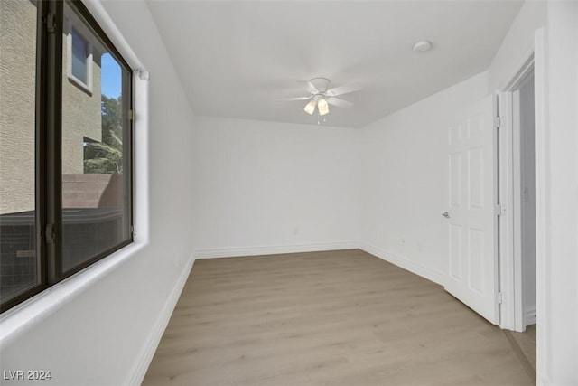 empty room featuring ceiling fan and light hardwood / wood-style flooring