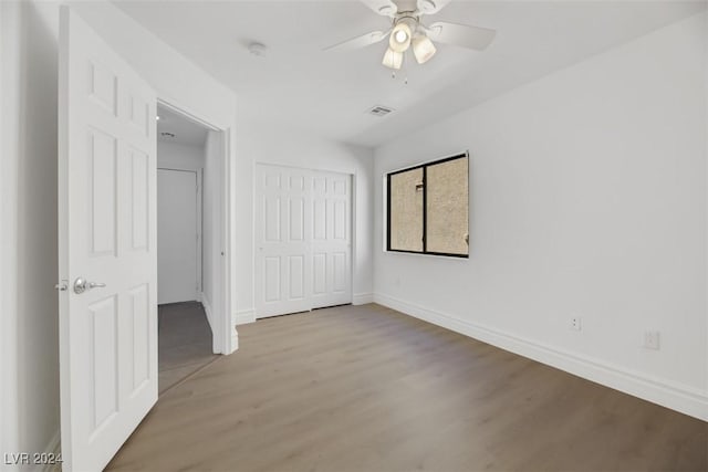 unfurnished bedroom featuring a closet, ceiling fan, and light hardwood / wood-style flooring