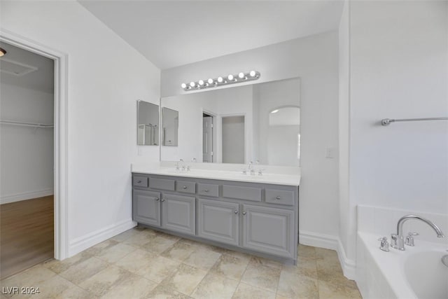 bathroom with vanity and a tub to relax in