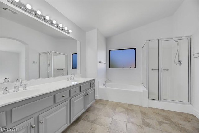 bathroom featuring tile patterned floors, vanity, plus walk in shower, and lofted ceiling