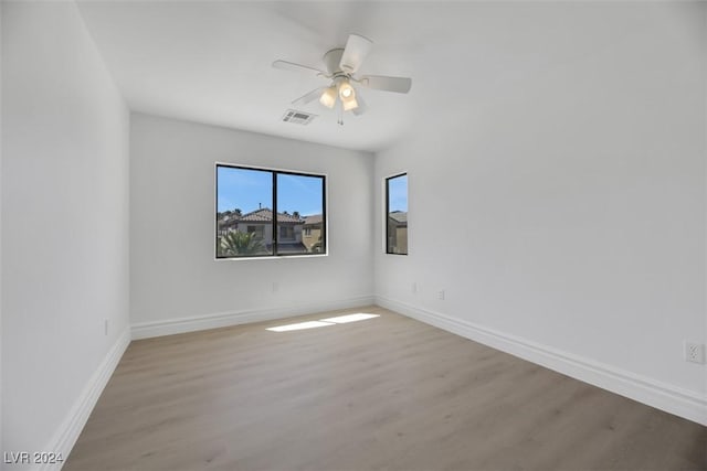 unfurnished room with ceiling fan and hardwood / wood-style floors