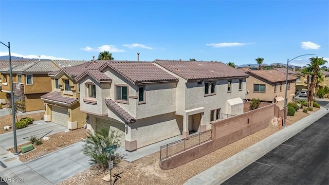 mediterranean / spanish home with a garage