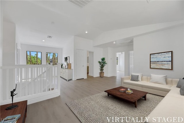 living room featuring light hardwood / wood-style floors and lofted ceiling